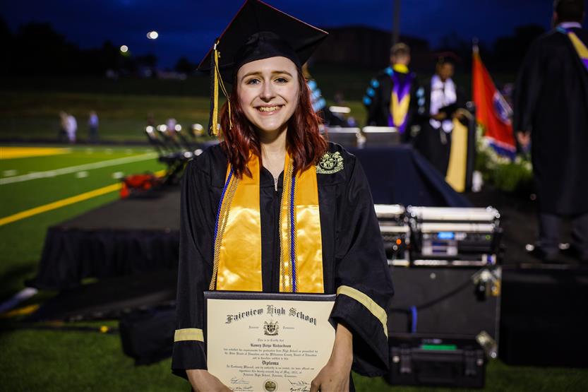 Students graduate on a football field